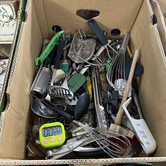 Box full of utensils and egg timers etc.