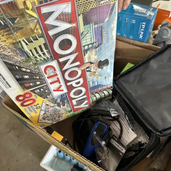 Box lot with Monopoly game and new dog clipper set etc.