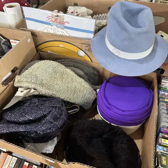 Box of assorted hats including felt.