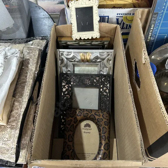 Box of selected photo frames, sheets, doylies etc.