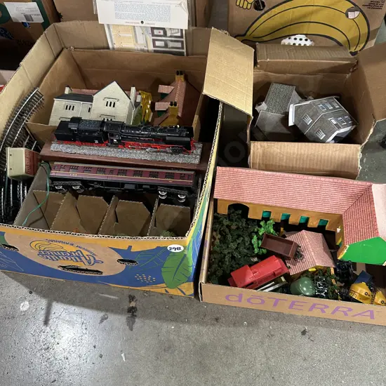 Two boxes trains, tracks, houses, and accessories.