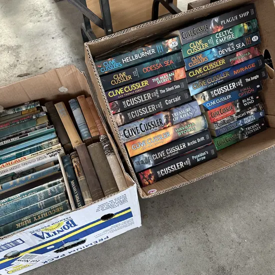 Two Boxes of Clive Cussler books and others.
