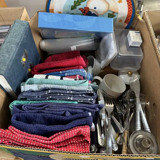 Box of cutlery, tea towels, sistema etc.
