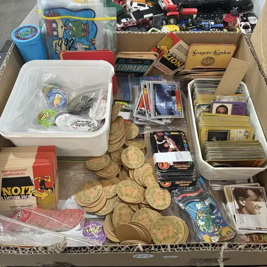 Box of collectables including Pokemon and batman cards.
