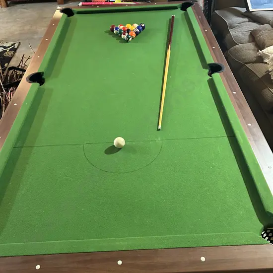 Pool table, balls one cue, felt good but some damage to side. table tennis top included