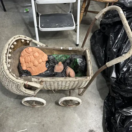 Vintage pram and terracotta ornmts.