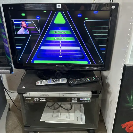 Panasonic 26 TV remote on cabinet and dual VHS/DVD