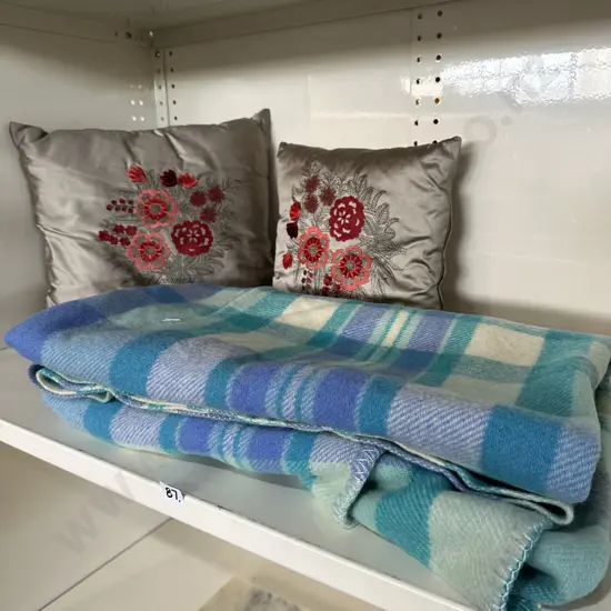 Woolen blanket and vintage cushions