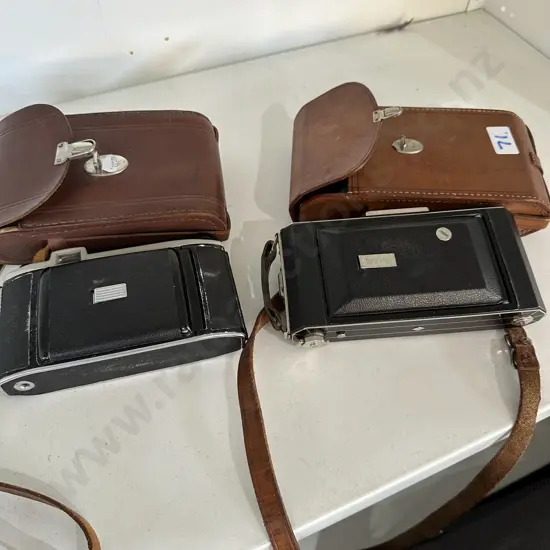 2 leather cased cameras