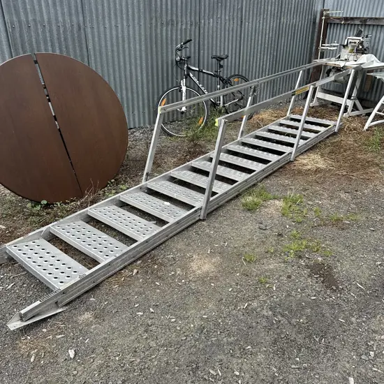 Aluminium construction stairs with folding hand rails