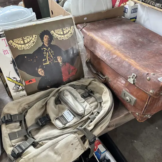 LPs, suitcase of books, climbing pack (ripped)