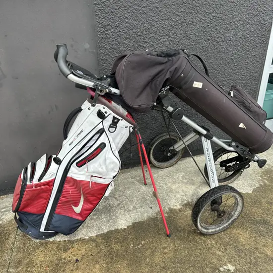 2 golf bags and trundler