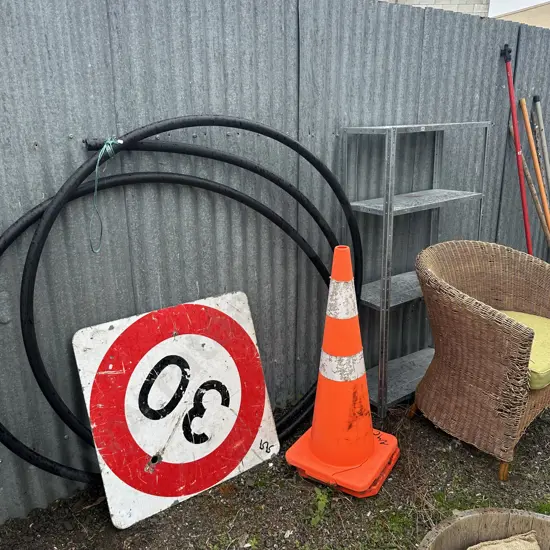 Wicker chair, pipe tube, cones, metal shelf and sign