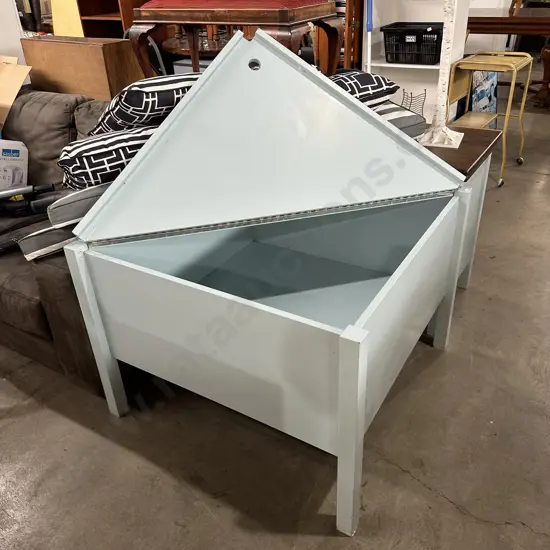 Custom built storage divider for single beds meeting in the corner of room