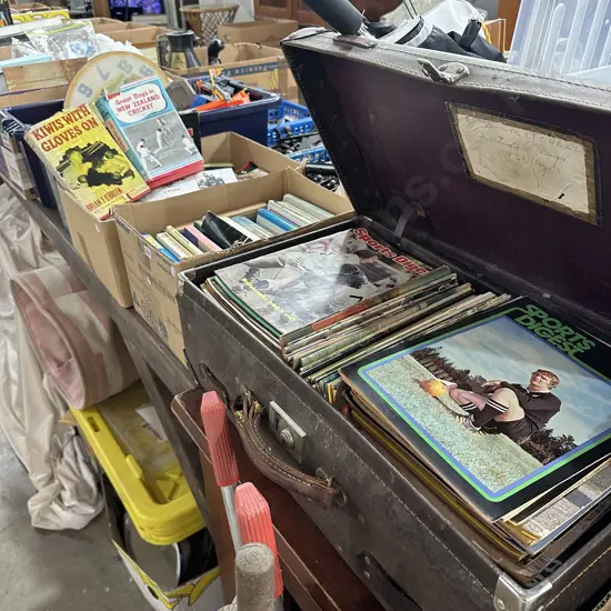 suitcase and 2 boxes of sporting books