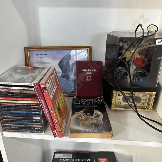 Shelf lot CDs DVDs, decorative clock etc