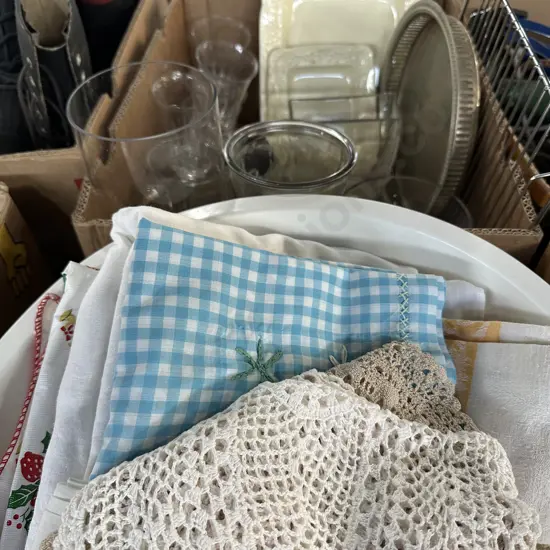 Basket of linen plus box of glass vases etc