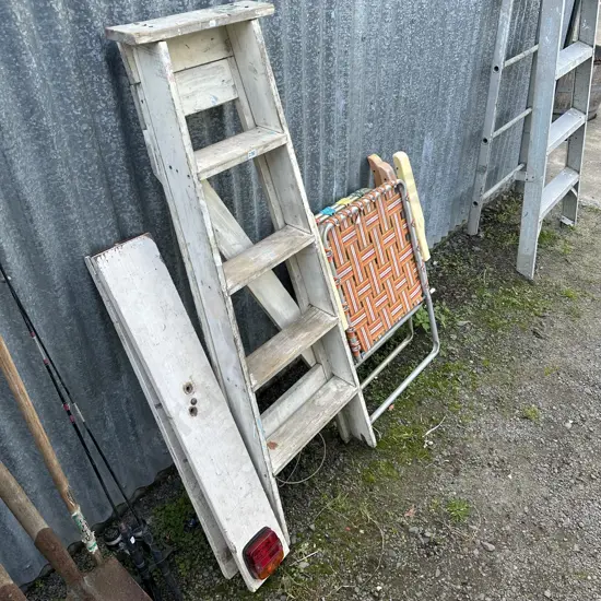 Wooden ladder, trailer lights and deck chairs