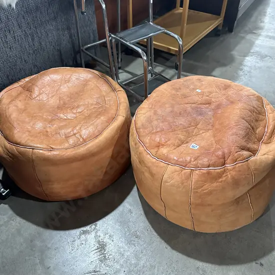 2 leather foot poofes