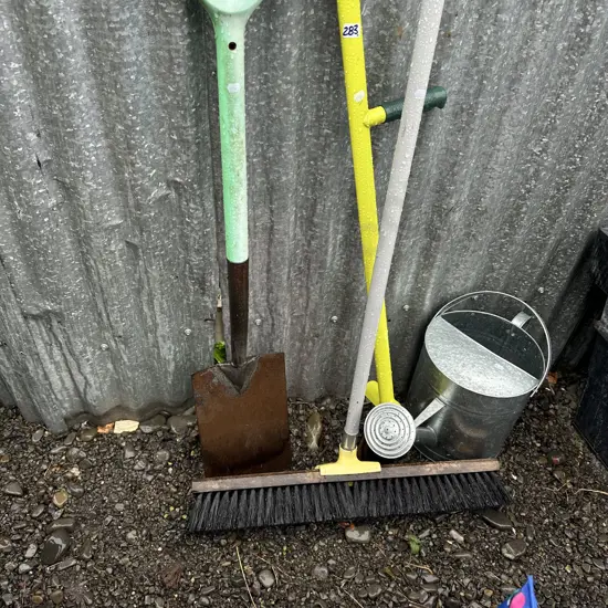garden tools and water can