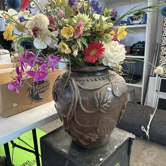 Large terracotta vase with applied decoration (plus flowers)