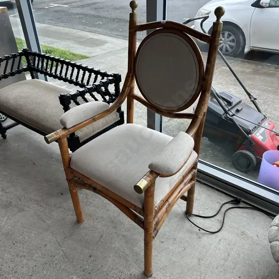 Cane, brass, padded chair