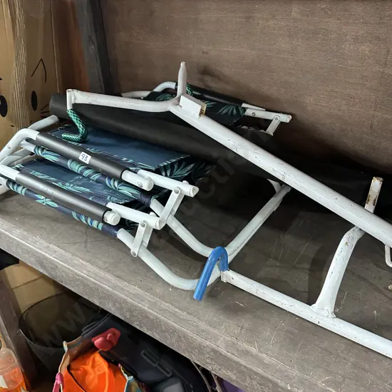 sand chairs, bike rack, broken wheel suitcase