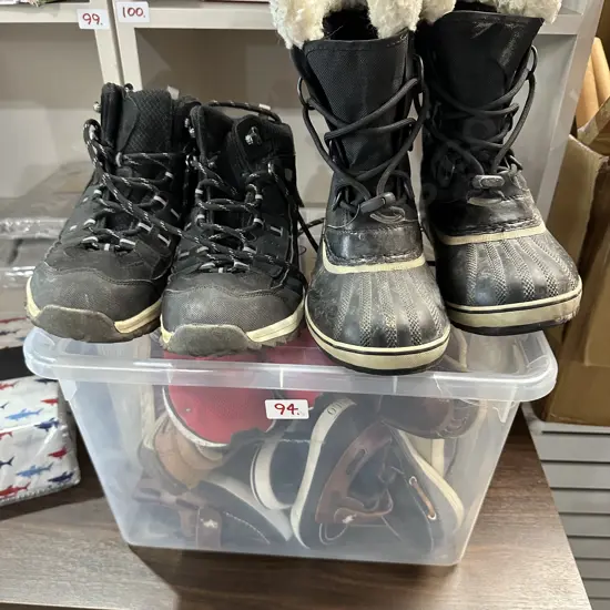 Bin of various shoes
