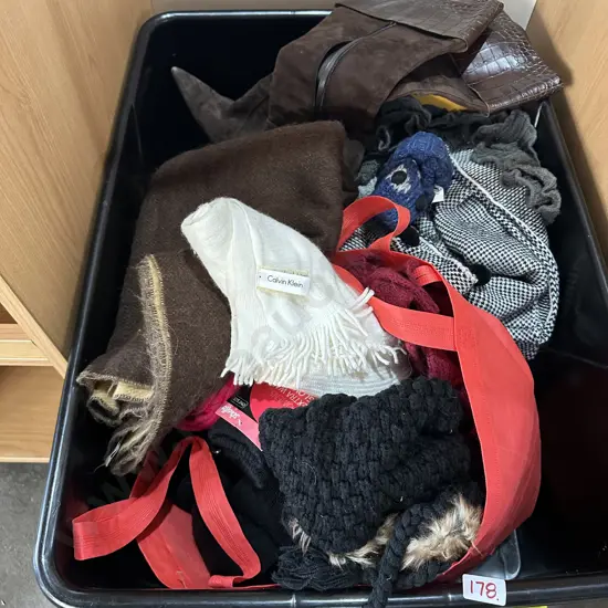 bin of woolen shawls, shoes and boots etc