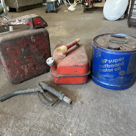 3 petrol cans and pump handle
