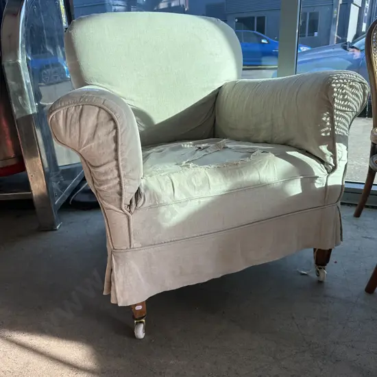 Vintage rolled arm lounge chair on porcelain casters