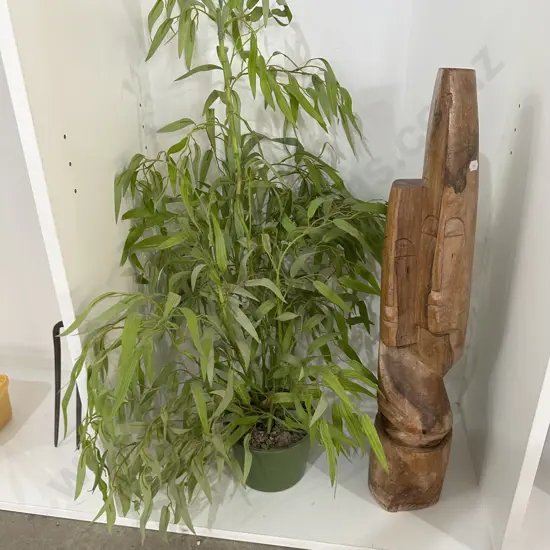 wooden carving and fake plant