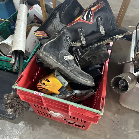 Bin of gumboots, motorbike boots, flippers etc.