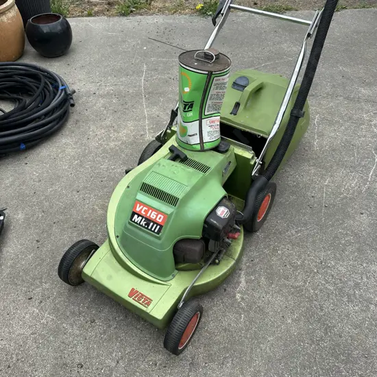 Vintage Victa mower and petrol can full.
