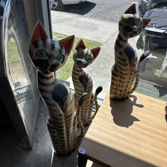 3 wooden cats