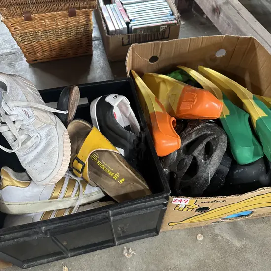 bin of shoes, flippers, helmets etc