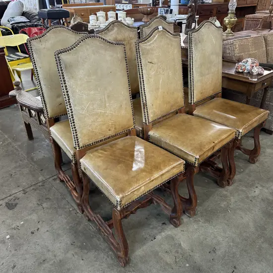 The matching leather high back dome carved chairs x 6