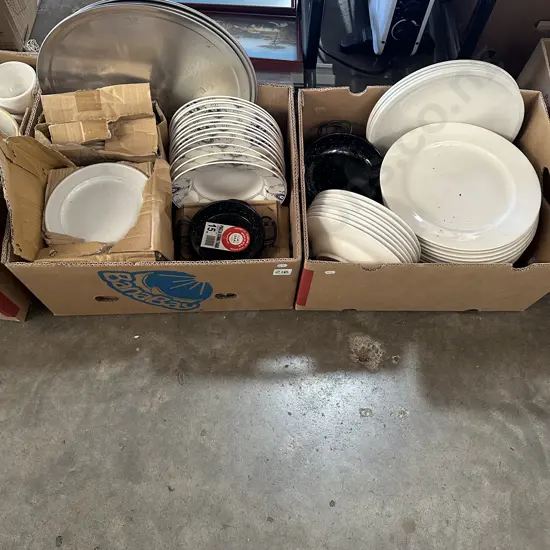 Two boxes plates, bowls, paella dishes.