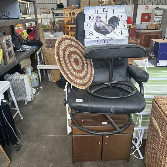 recliner chair and foot rest, tapa art, clock, cupboard