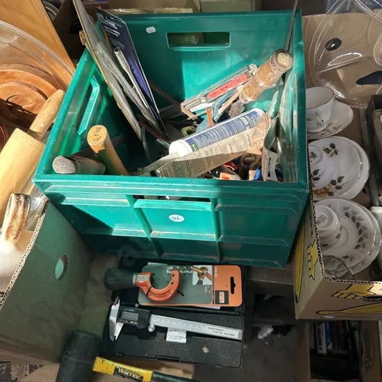 Bin of assorted tools including digital calipers.