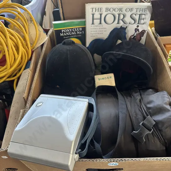 Box with sleeping bag, horse riding helmets and polaroid etc.
