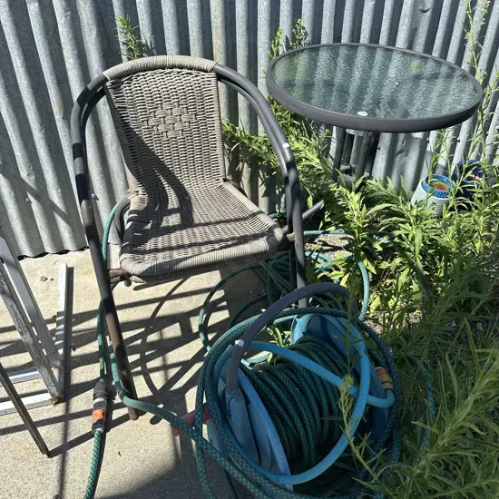 average patio table and chairs plus hose and reel