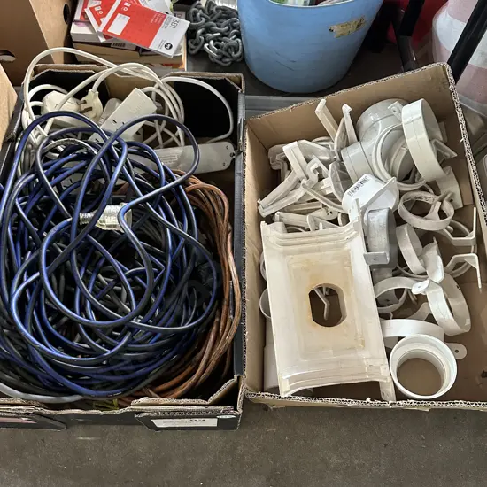 Two boxes of extension leads, spouting and downpipe brackets etc.