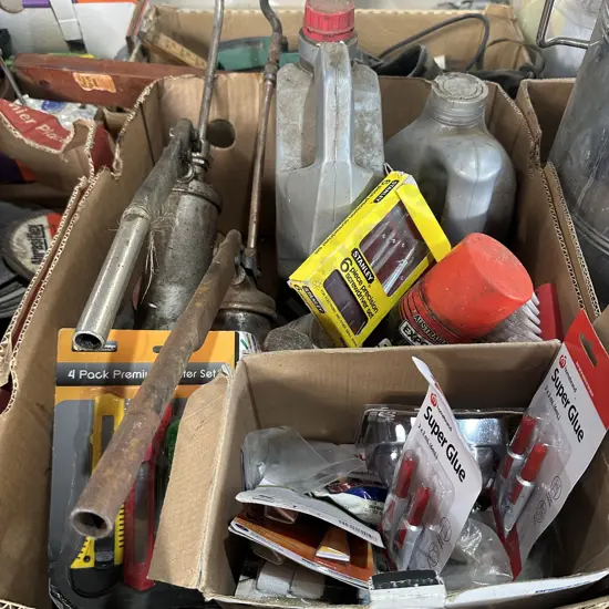 Box lot with grease guns, automatic transmission fluid, super glue and knife packs etc.