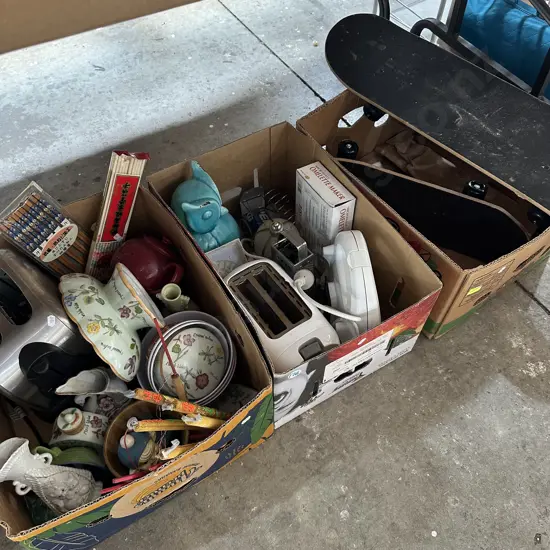Three boxes skateboards, toasters etc.