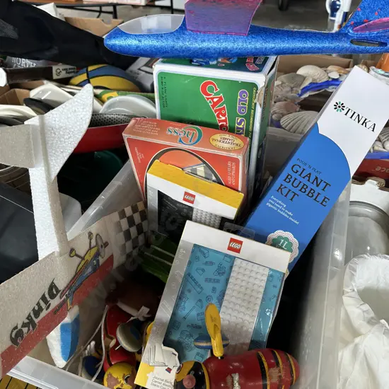 Bin of vintage toys including Chess, buzzy bees and Lego notebook etc.