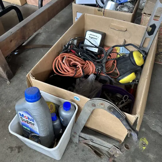 Box of hardware including "top up" oil and battery charger etc.