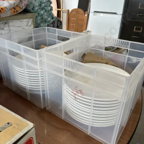 Two bins of white plates.