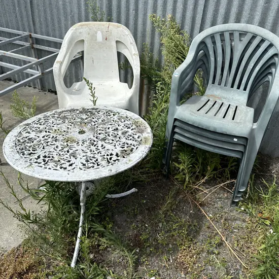 Six plastic chairs and outdoor table.