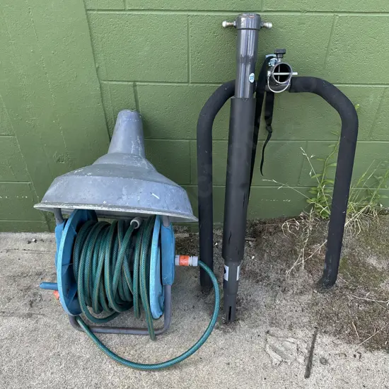 Bike rack, light shade, hose and reel.